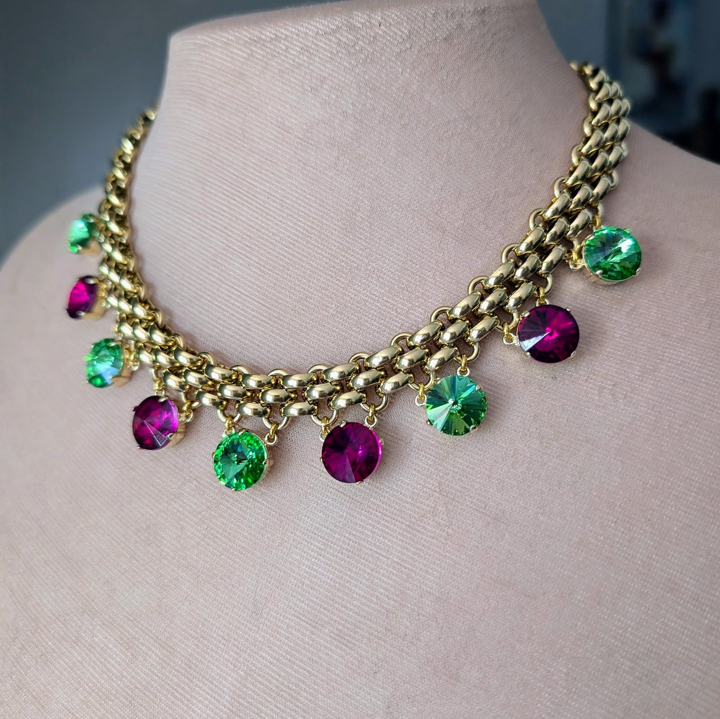 Chunky gold necklace with peridot and fuchsia charms