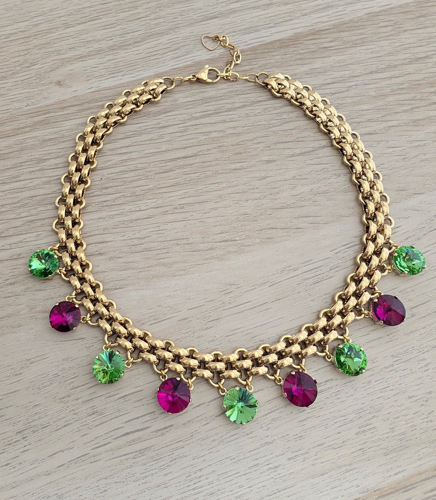 Chunky gold necklace with peridot and fuchsia charms