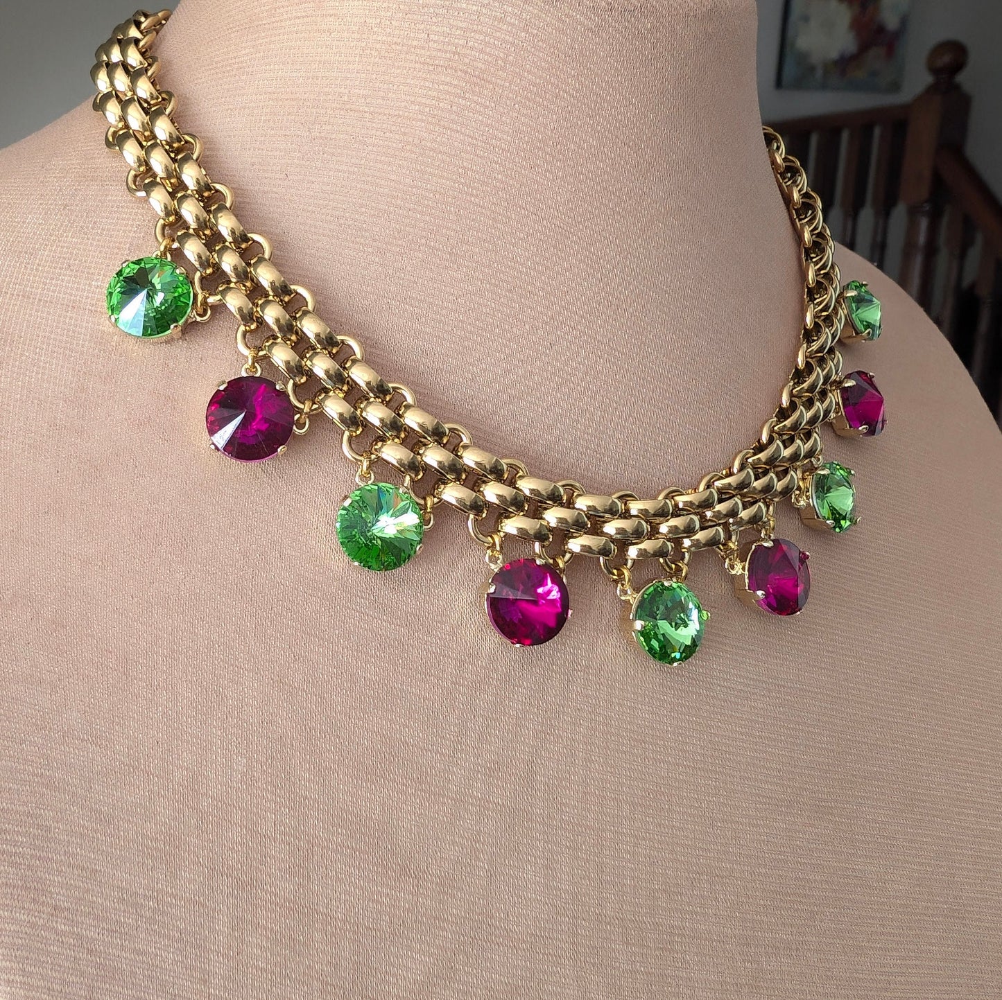 Chunky gold necklace with peridot and fuchsia charms
